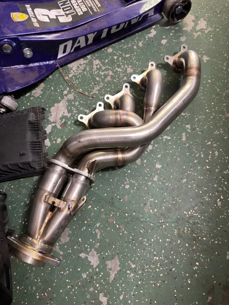 Stainless steel exhaust headers ready for automotive repair work